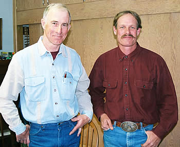 Two men (Brett Bronson and Hugh Weaver) standing together