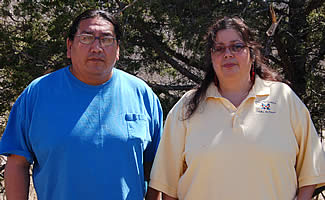 David Louis (man at left) with his apprentice Liz Anderson (woman at right) stadning side by side.