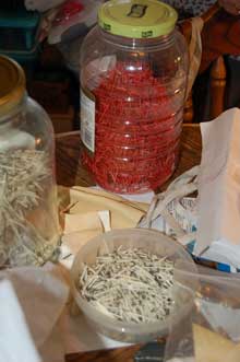 Jars and bowls of clean and dyed quills. One large jar contains red quills.