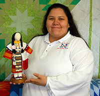 Robin Robertson (woman) holding beaded doll