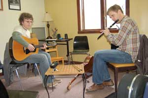 Seated man at left (Nathan Glazier) plays Irish guitar. Seated man at right  (teacher Brian Miller) plays flute.